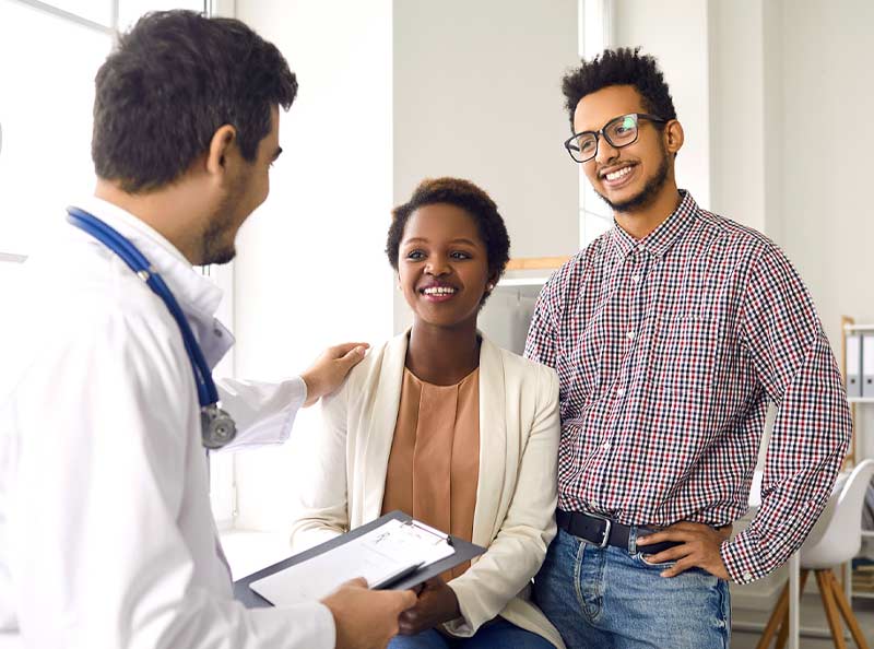 patient and husband talking with doctor