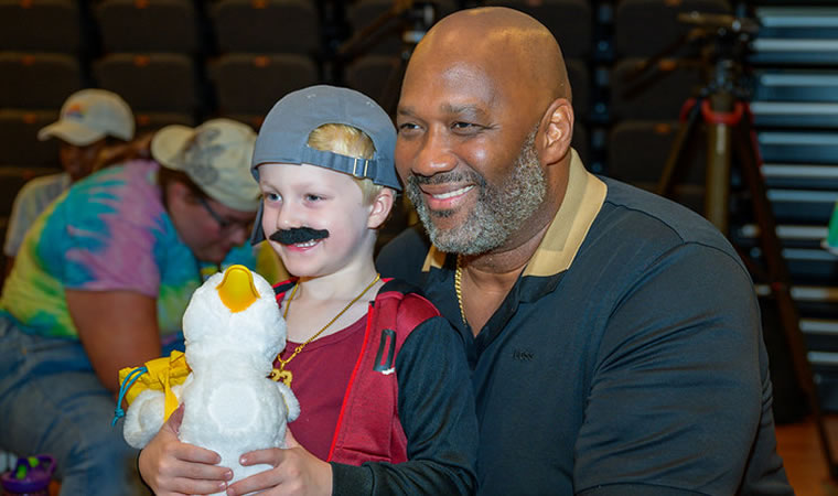 
            Brad Knox with cancer patient, giving them a My Special Aflac Duck