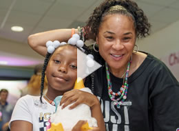 Dawn Staley giving a patient a My Special Aflac Duck