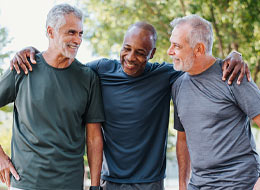 three men with arms wrapped around each other