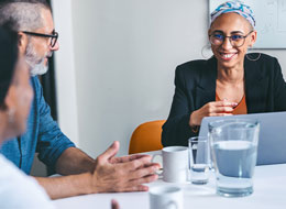 employees chatting at table